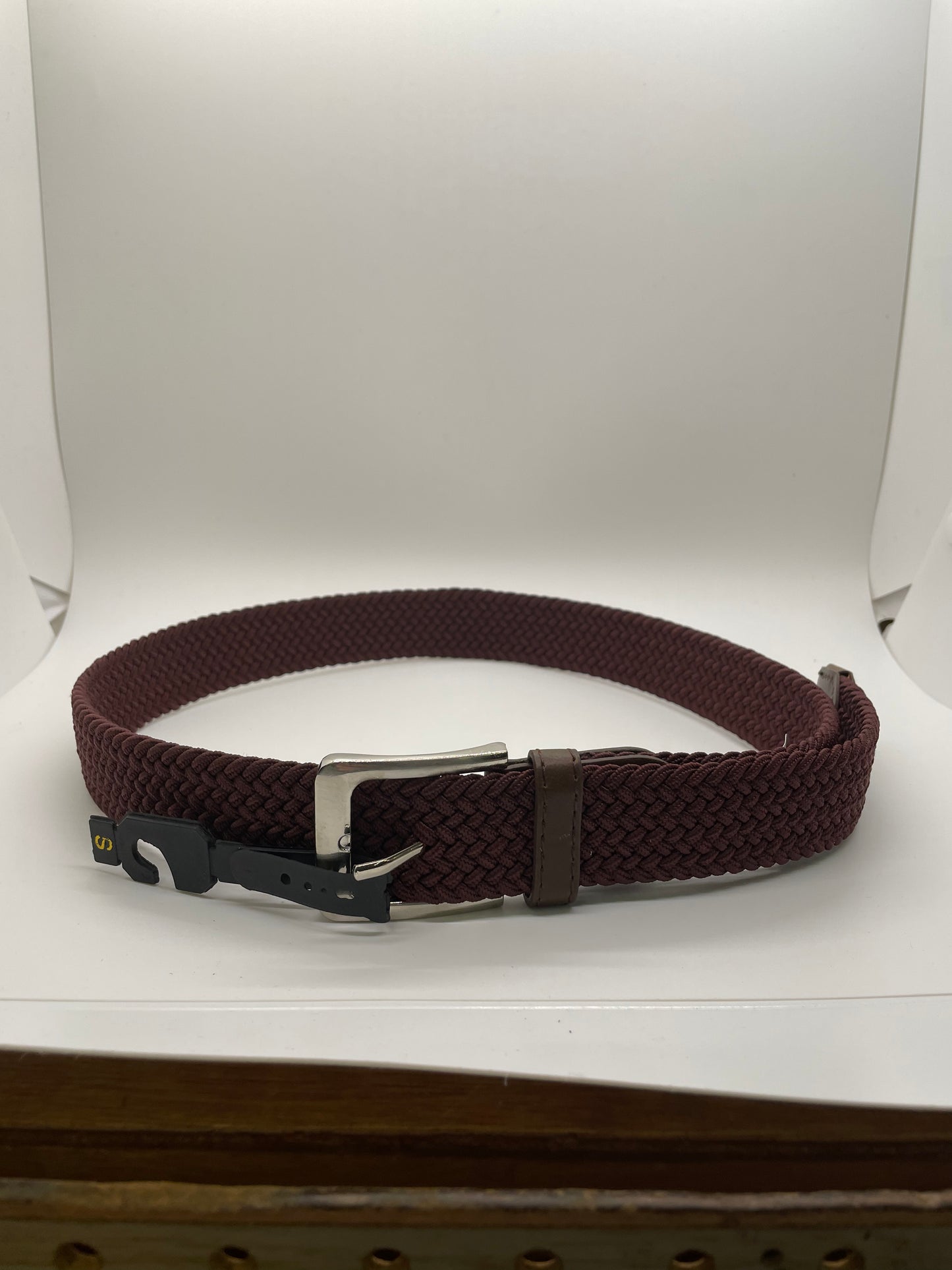 "Black stretch knit belt with a quilted texture and a drawstring closure"