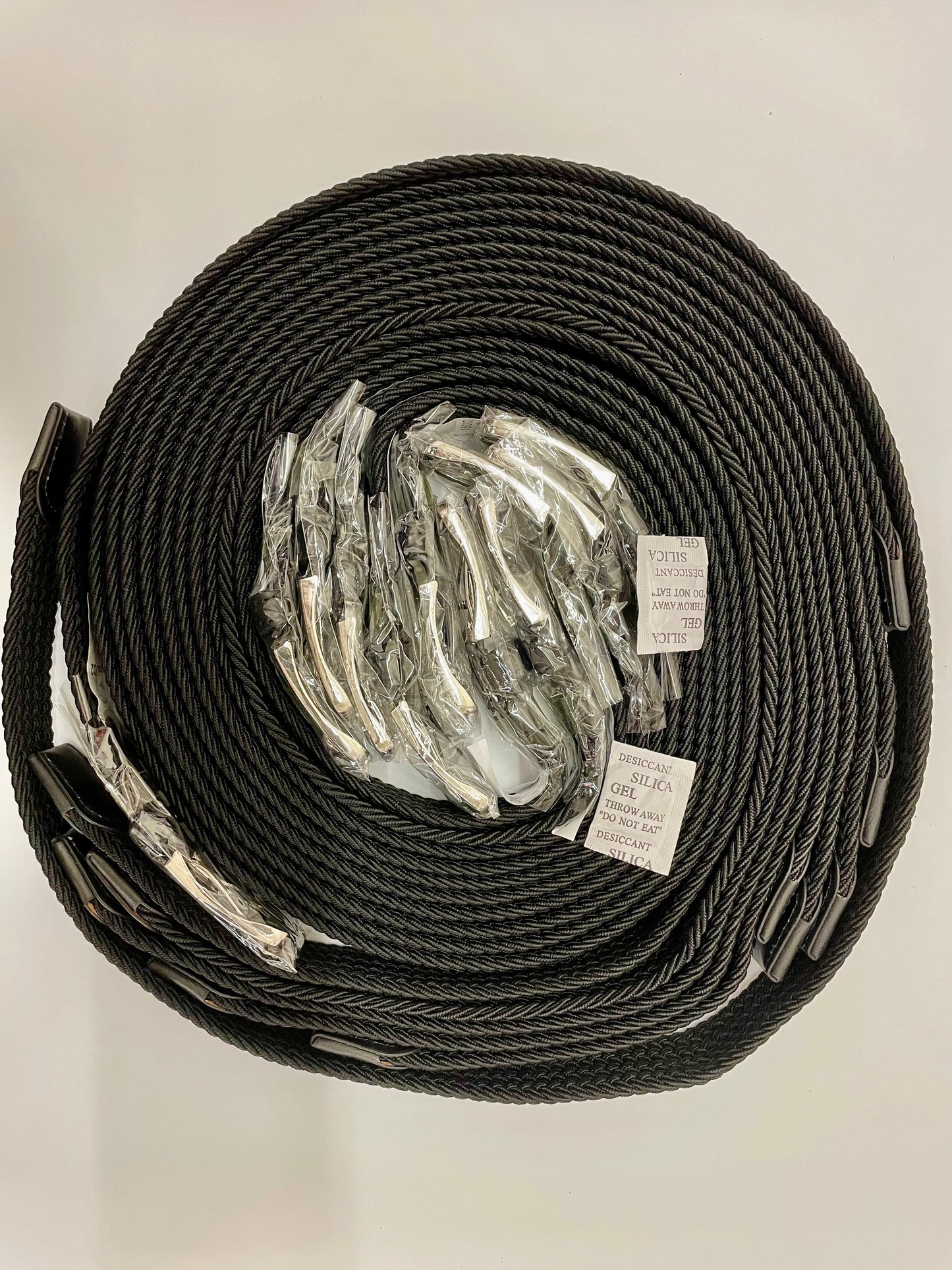 "Black stretch knit belt with a quilted texture and a drawstring closure"