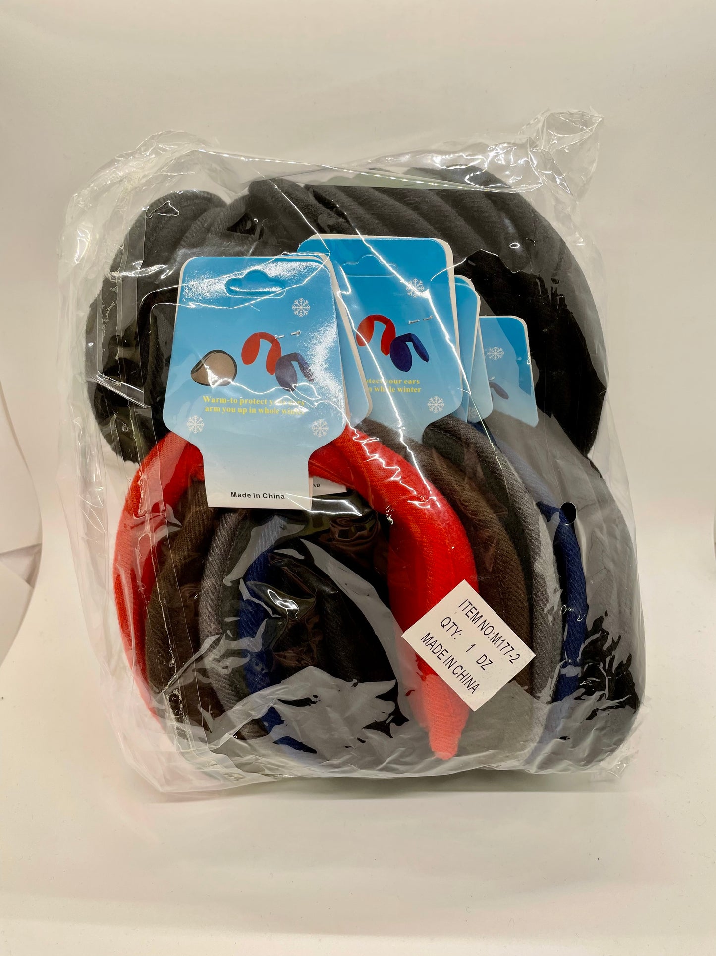 Maroon ear muff with a padded headband and a knit flower detail