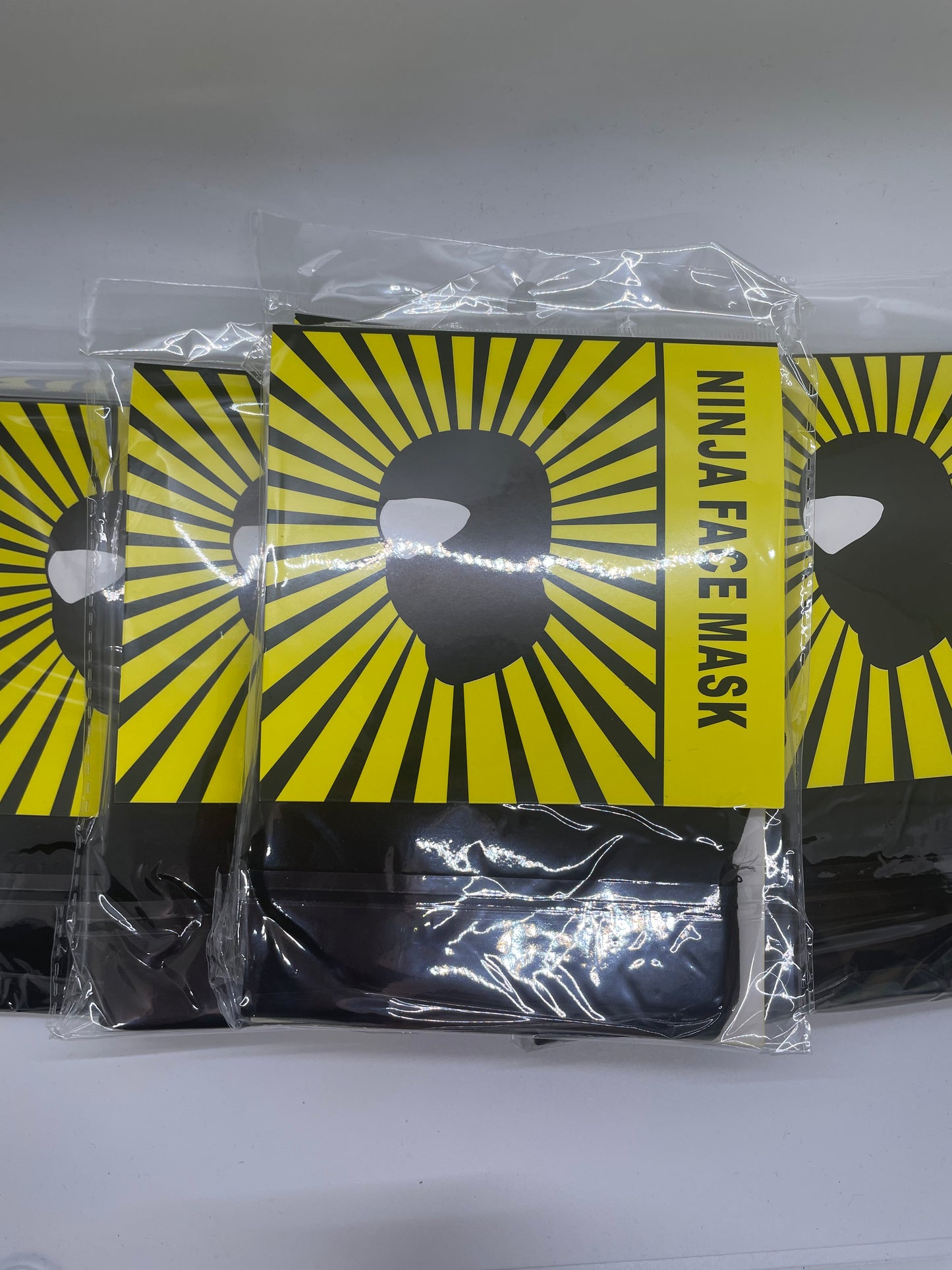 "Gray ninja mask with a ribbed knit texture and a buckle closure"