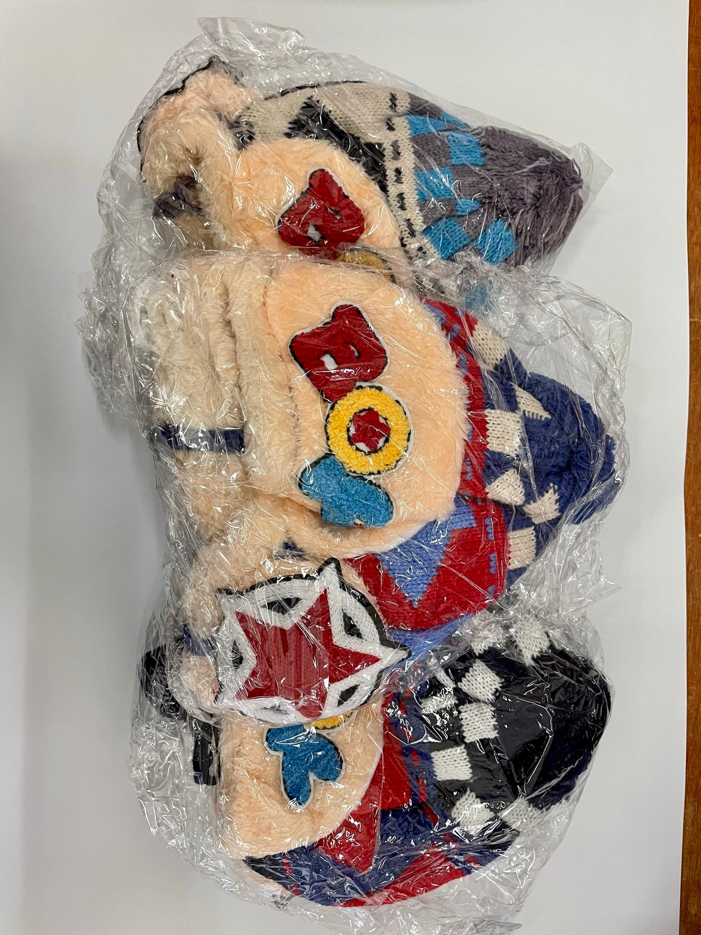 "Gray kid's winter hat with a ribbed knit texture and a buckle closure"