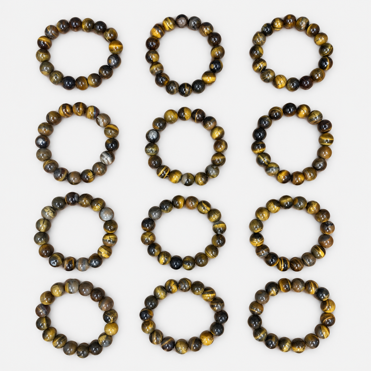 Complete 12-bracelet assortment of brown & gold round bead bracelets: 12 brown-and-gold round-bead bracelets with individual variations in bead markings.
