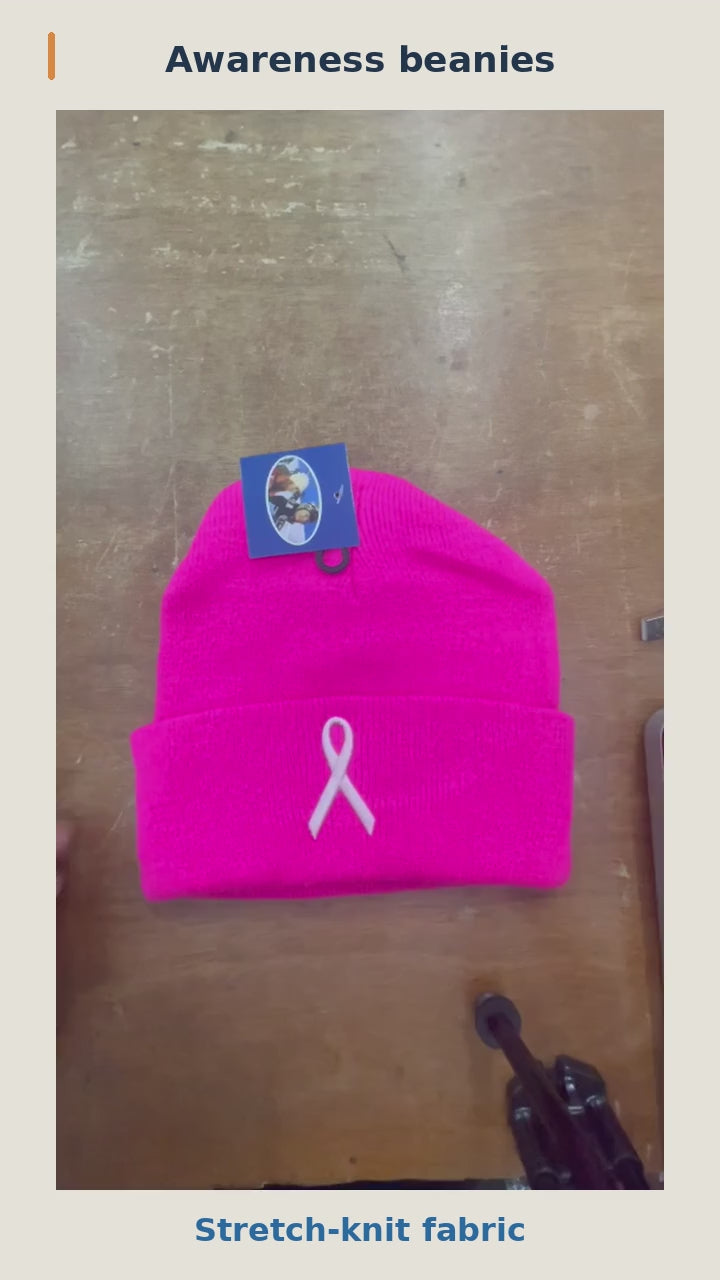 Breast cancer awareness beanies: knit stretch, cuff and interior, and pink ribbon motif on a mannequin, followed by the color assortment. 12-second silent product video.