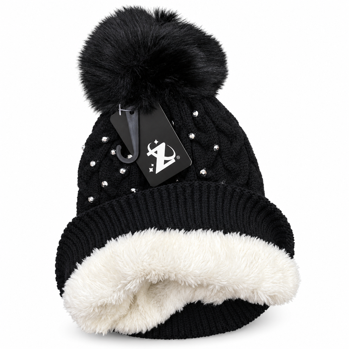 Black rhinestone pom-pom beanie with cuff turned outward to show plush ivory lining.