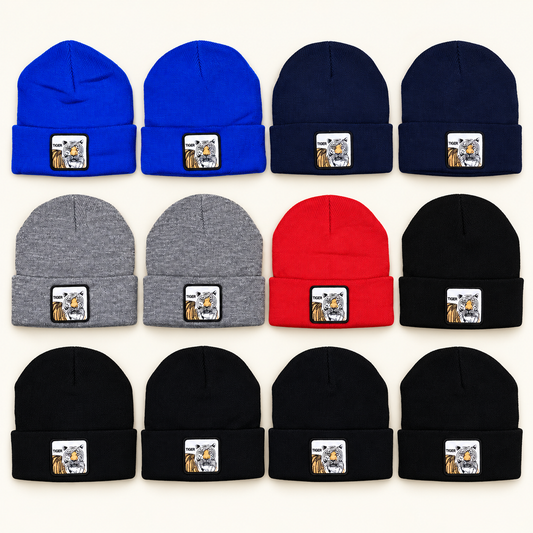 Twelve tiger-patch knit beanies on an off-white background, showing the mixed-dozen color assortment.