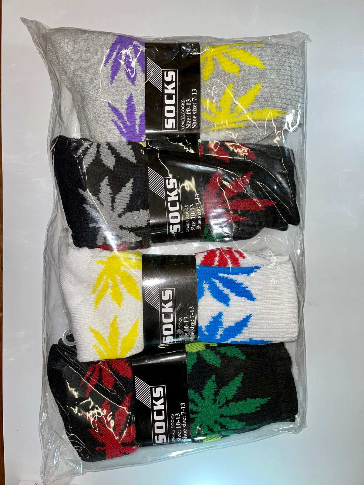 Packaged crew socks with multicolored leaf patterns