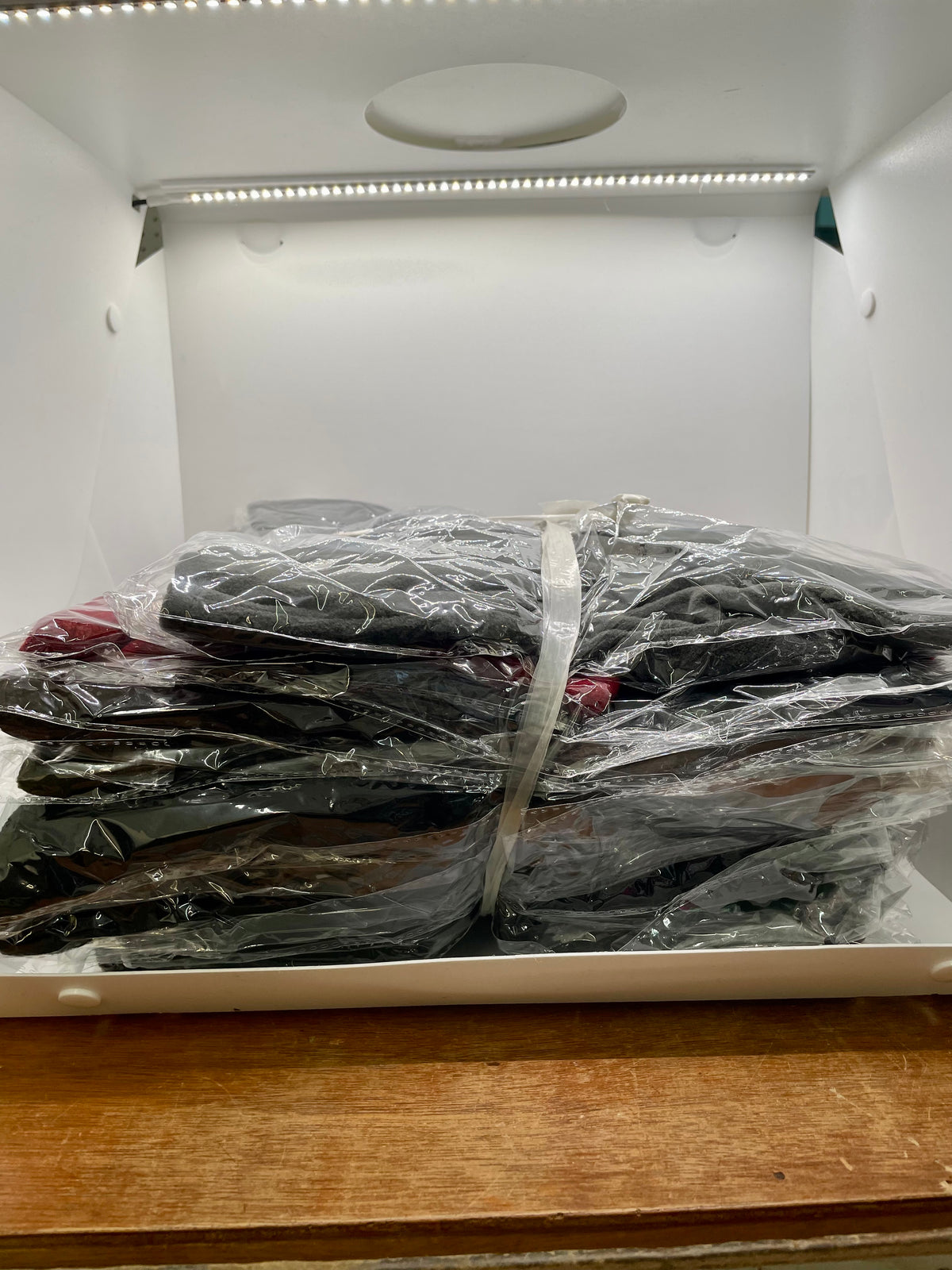 Stack of packaged face-covering hoods