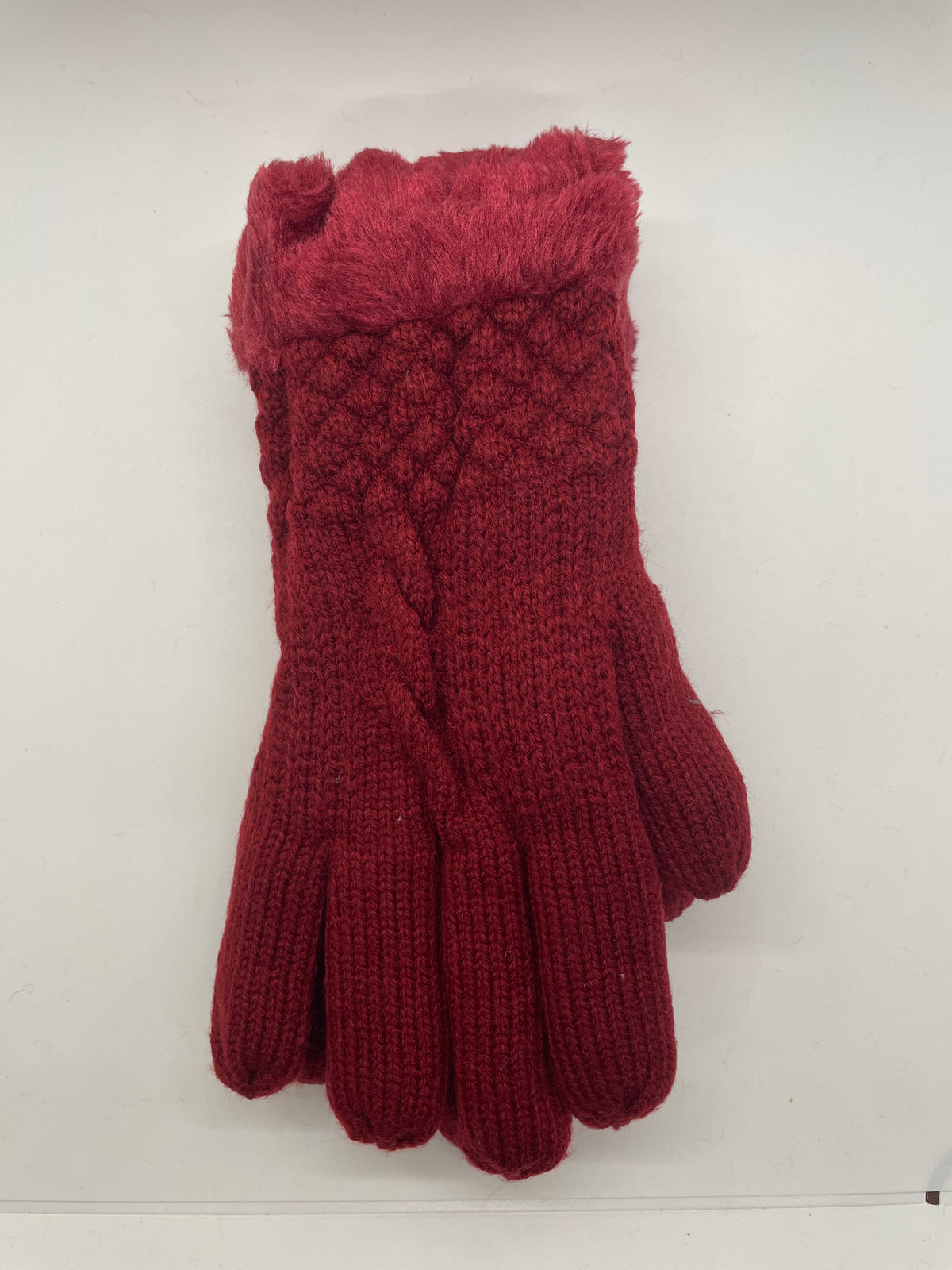 Red cable-knit winter gloves with fuzzy cuffs