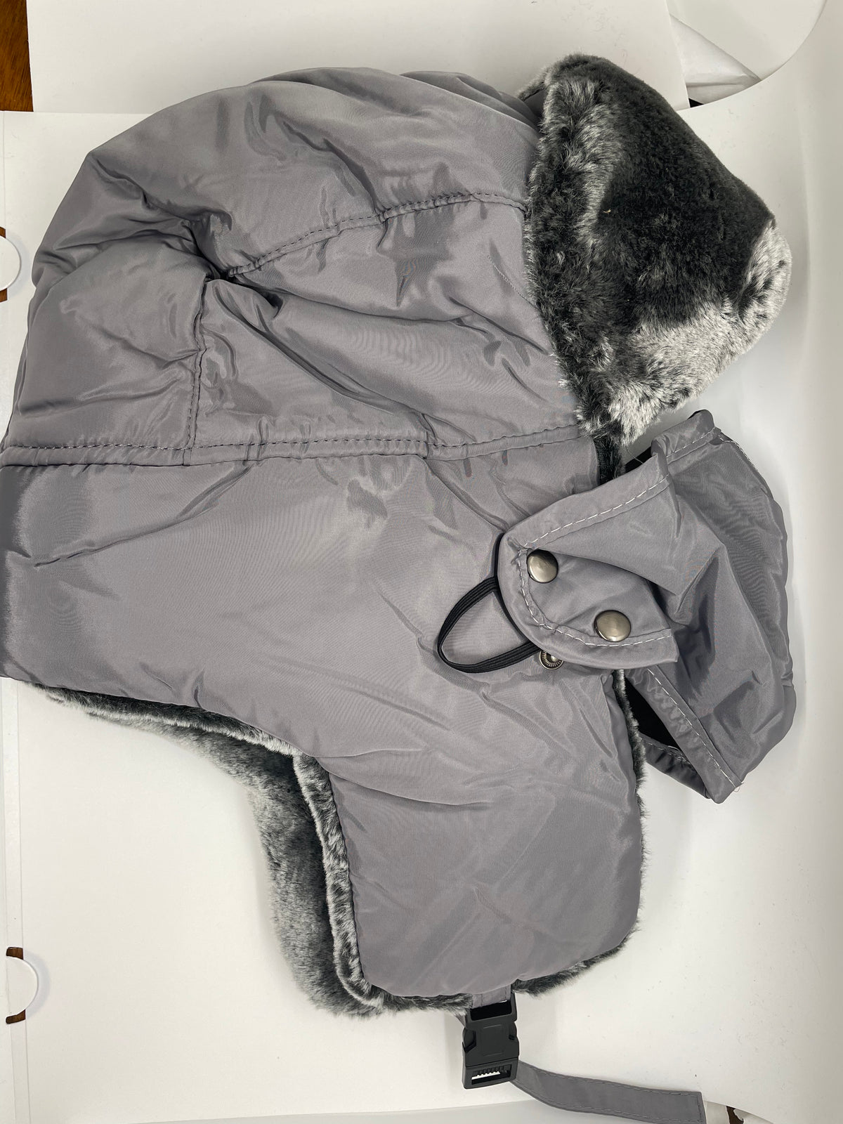 Gray ushanka hat with ear flaps and furry trim