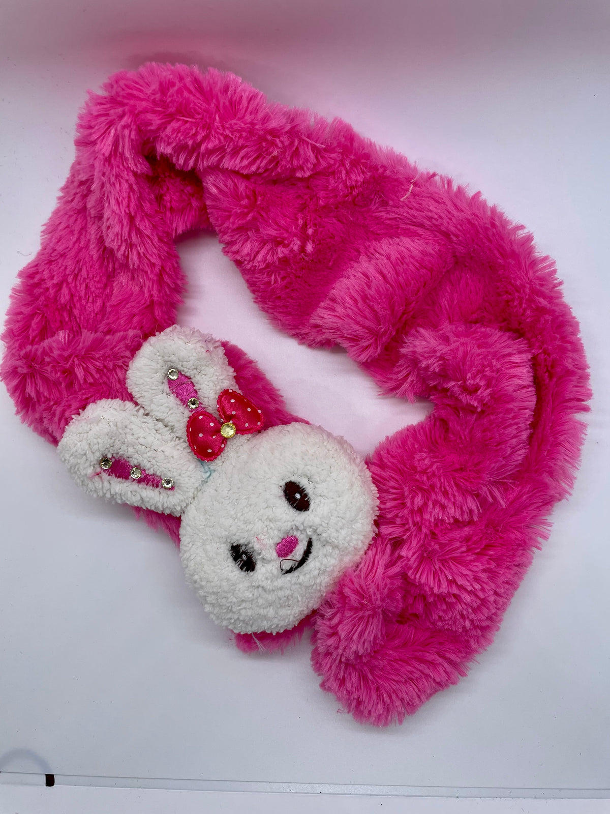Bright pink plush scarf with rabbit face decoration