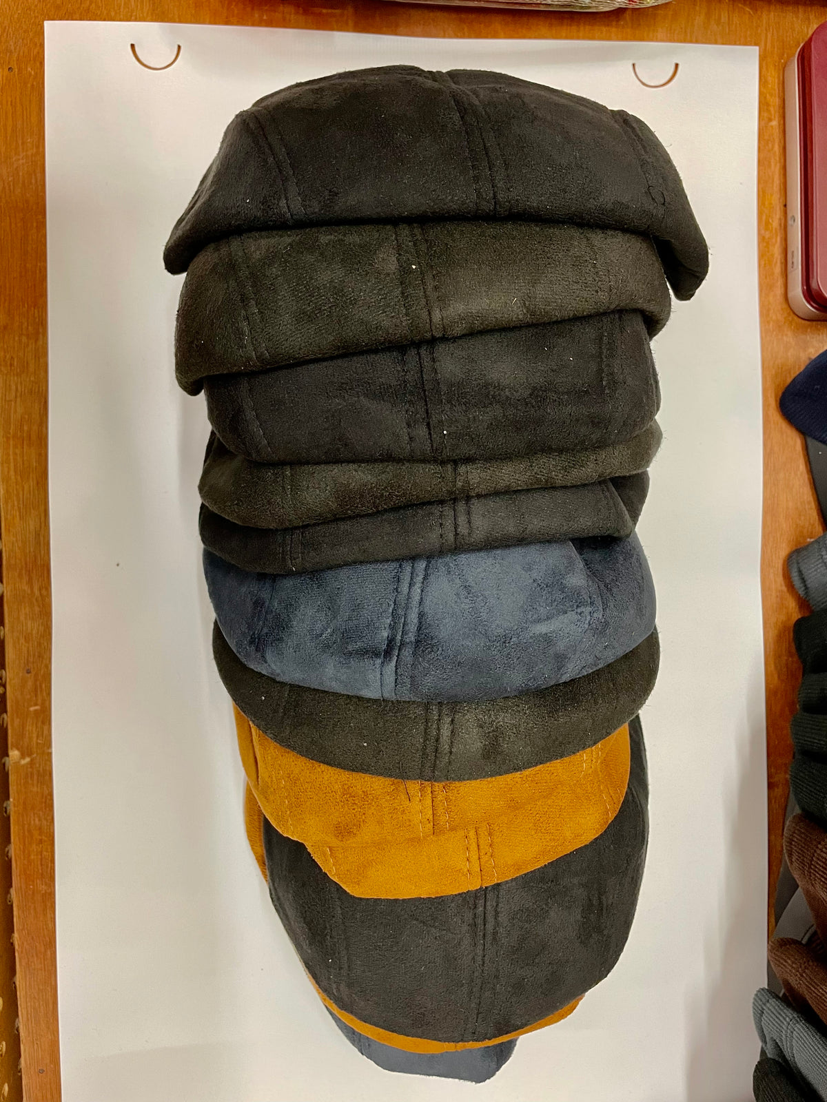 Stack of flat hats in several colors