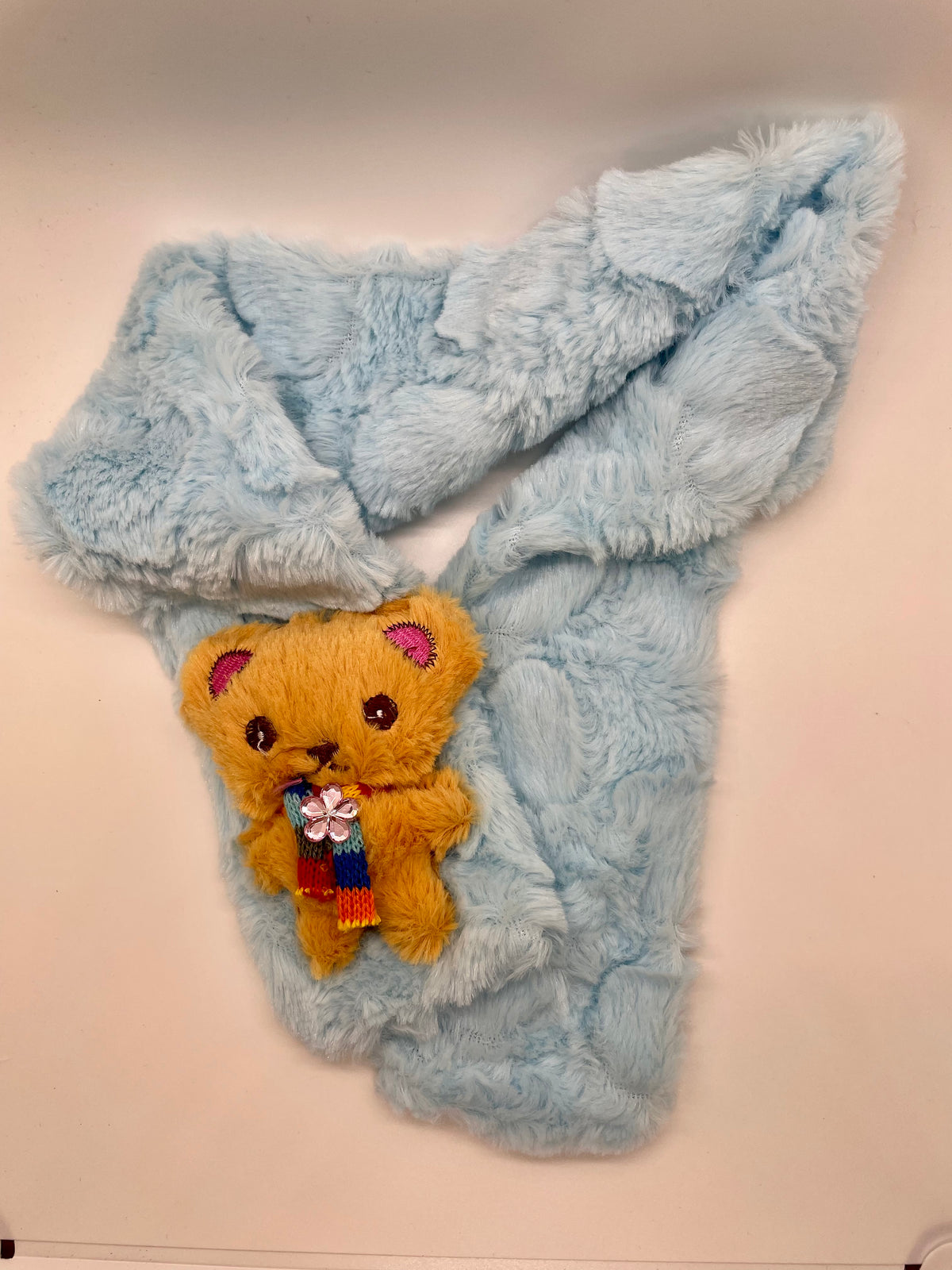 Light blue plush scarf with bear decoration