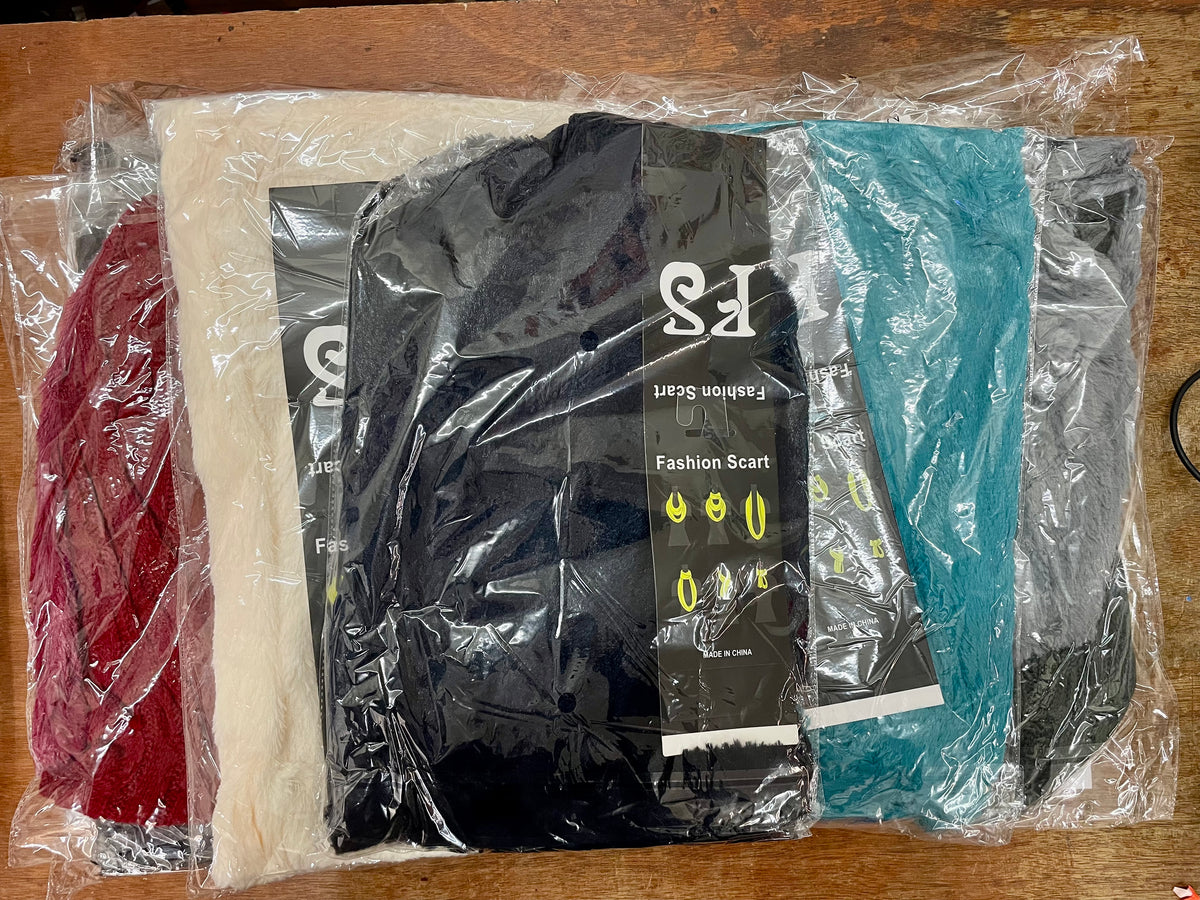 Packaged braided infinity scarves in several colors