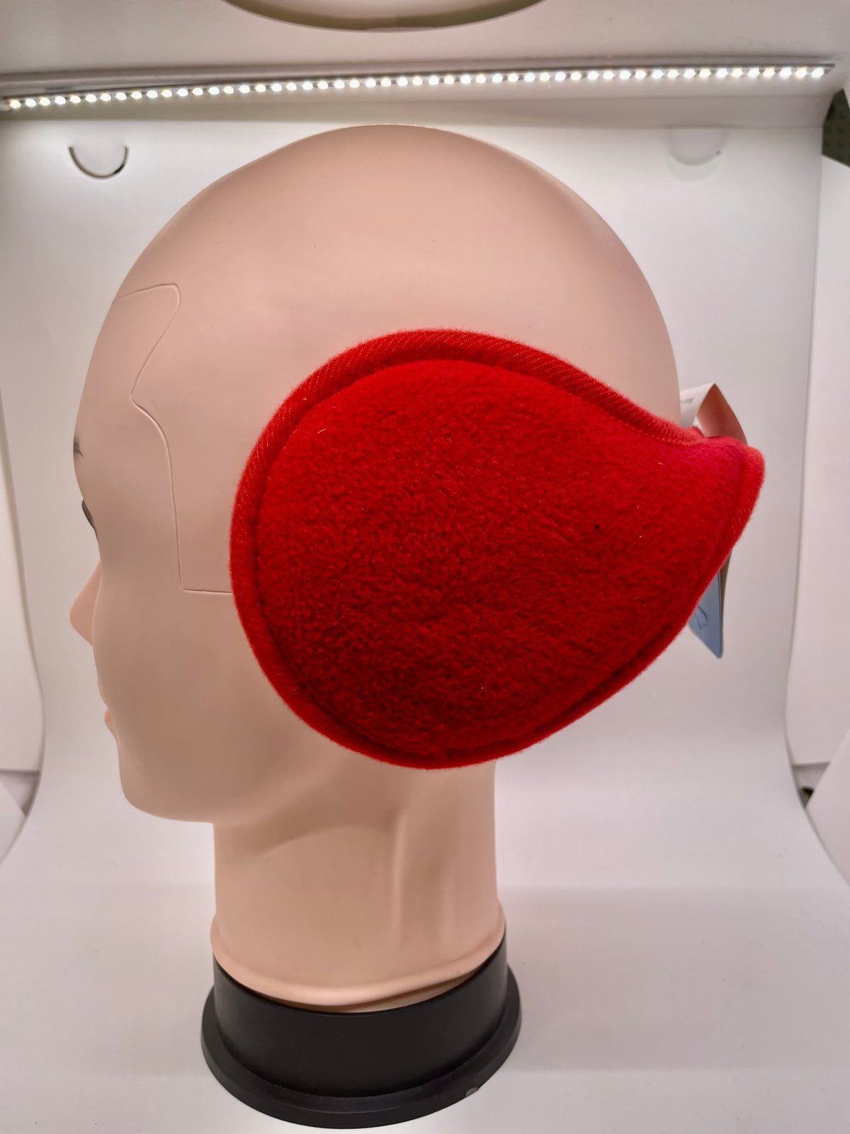 Red ear muffs on a mannequin