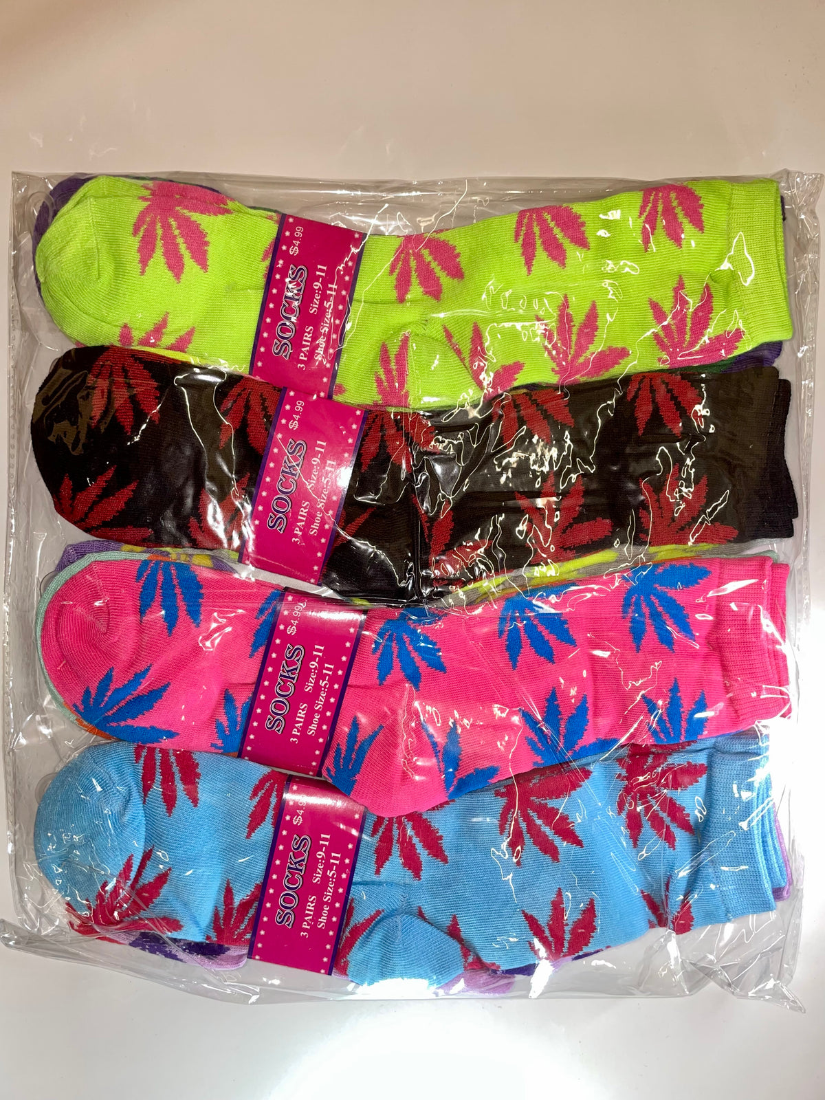 Packaged women’s crew socks with colorful leaf patterns