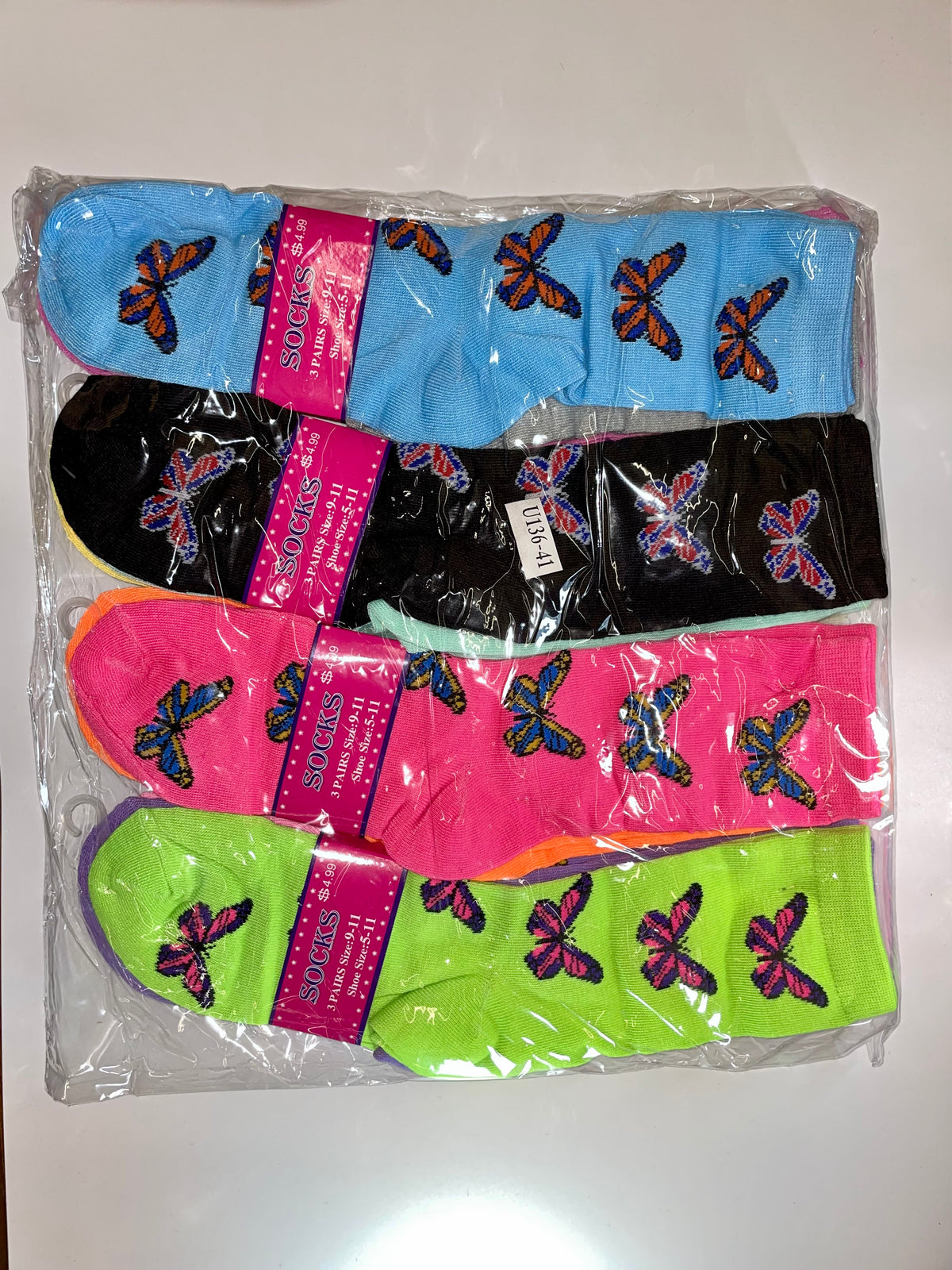 Packaged women’s crew socks with butterfly patterns