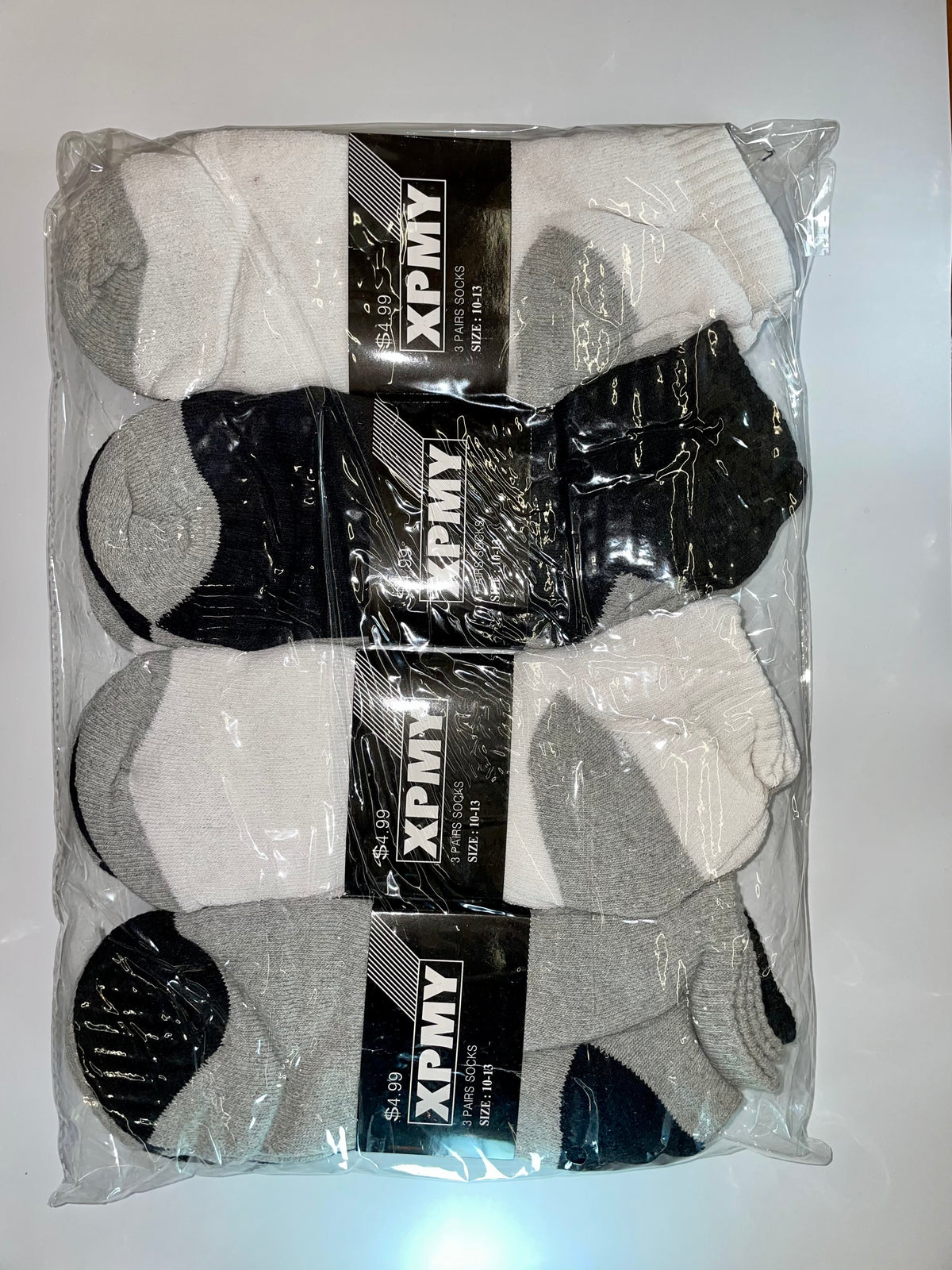 Packaged white, black and gray men’s ankle socks
