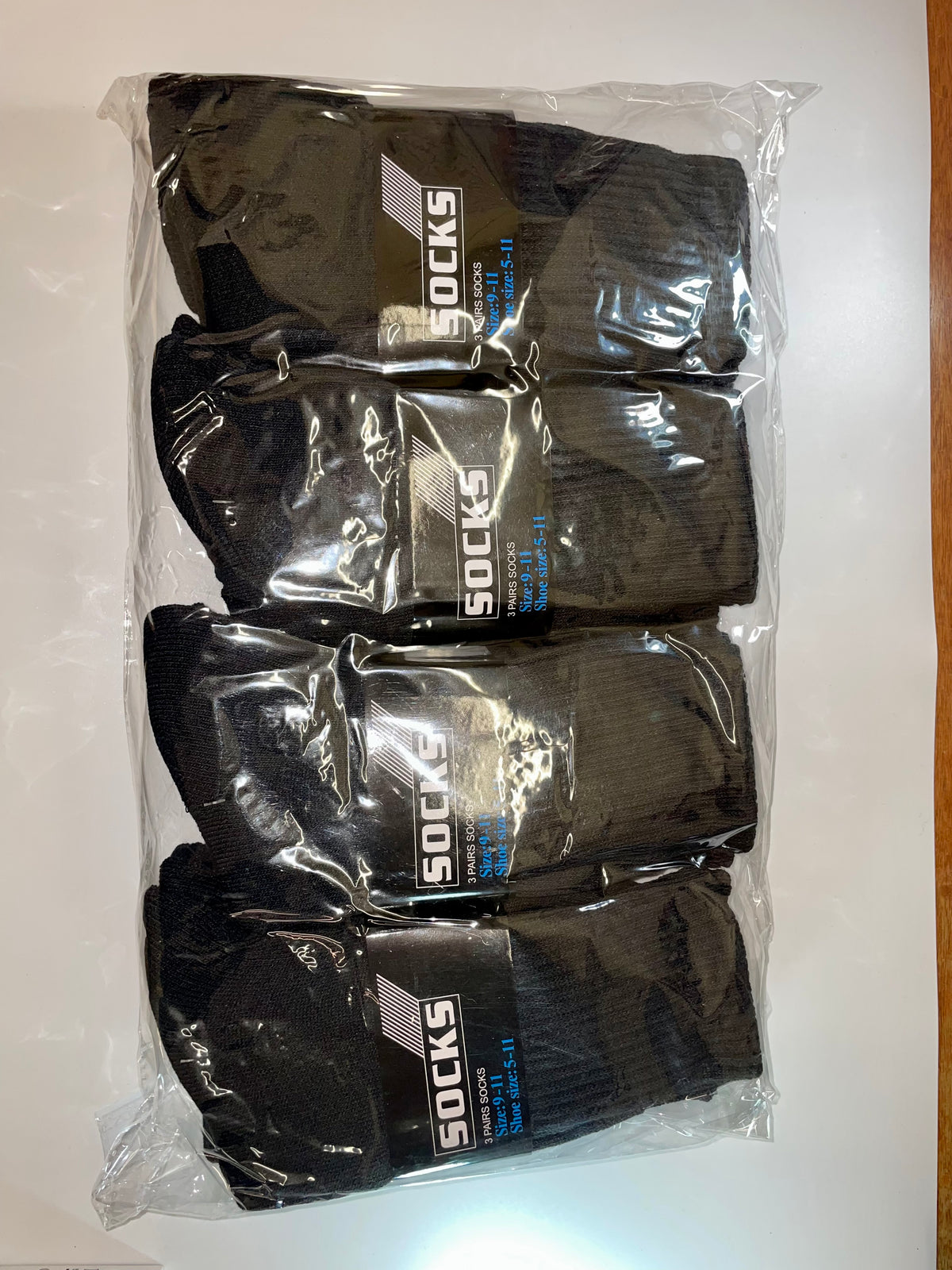 Black crew socks in clear packaging