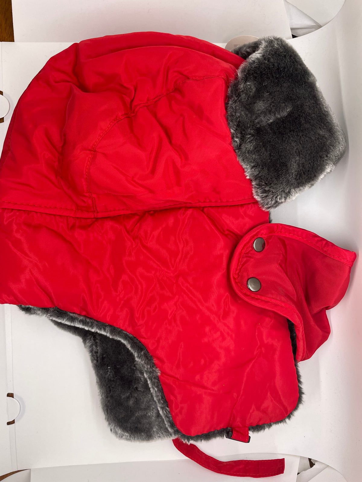 Red ushanka hat with ear flaps and furry trim