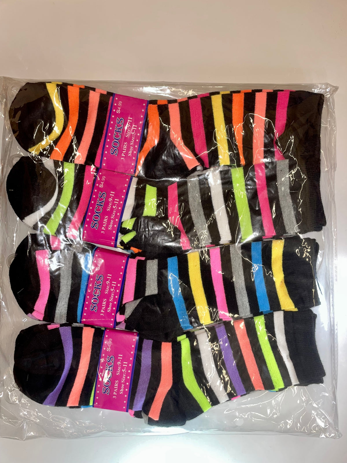 Packaged women’s crew socks with multicolored stripes