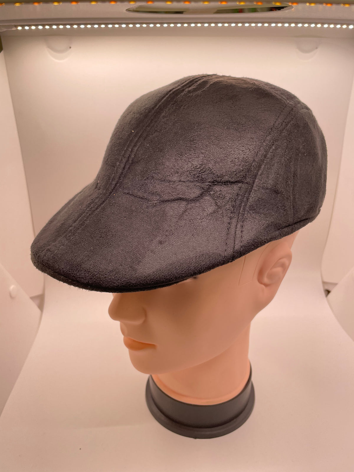 Brown gray flat hat on a mannequin