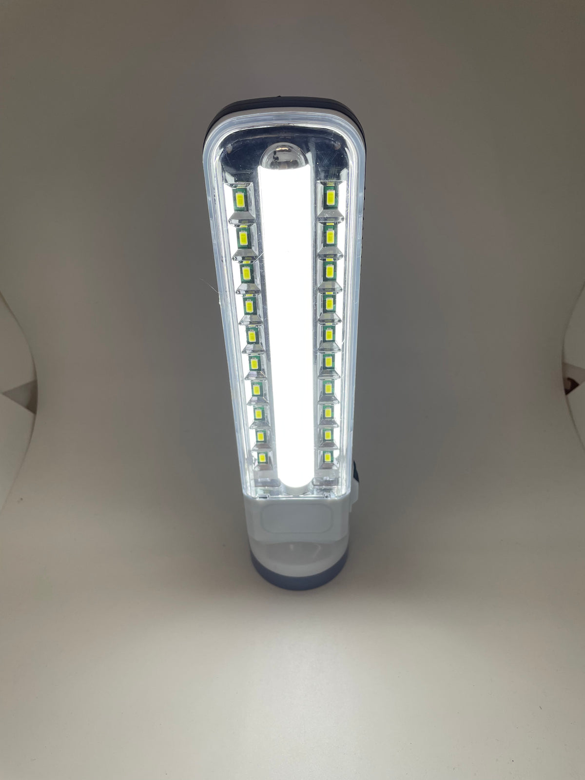Front view of rechargeable flashlight with side LEDs lit