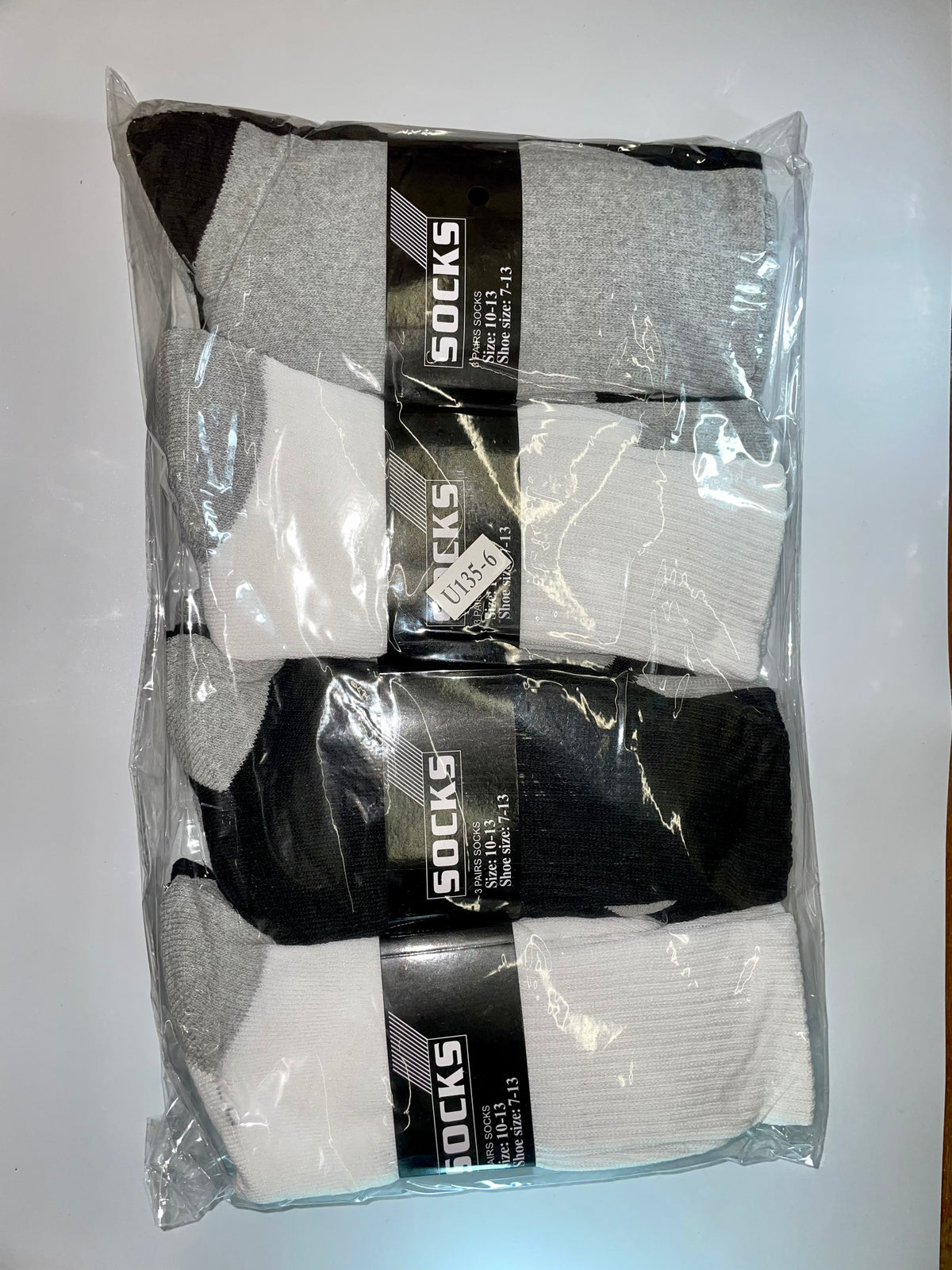 Packaged white, gray and black crew socks