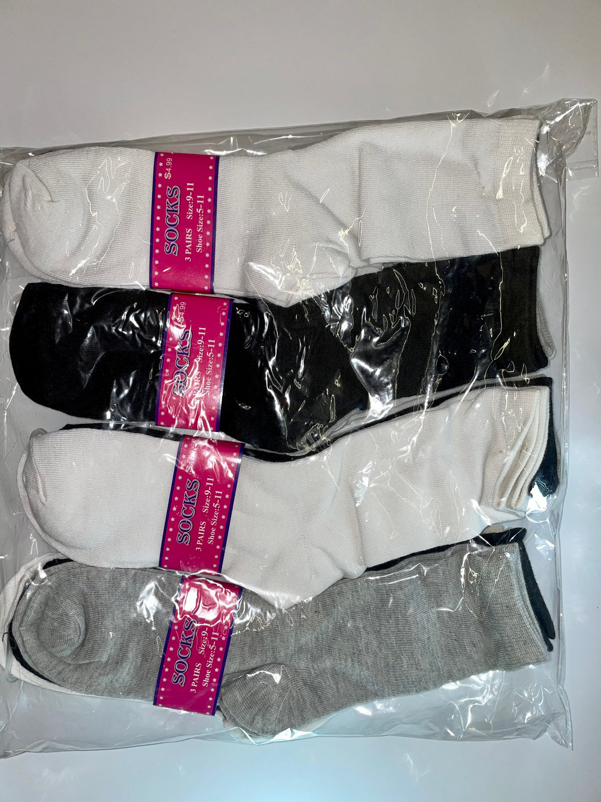 Packaged white, black and gray women’s crew socks