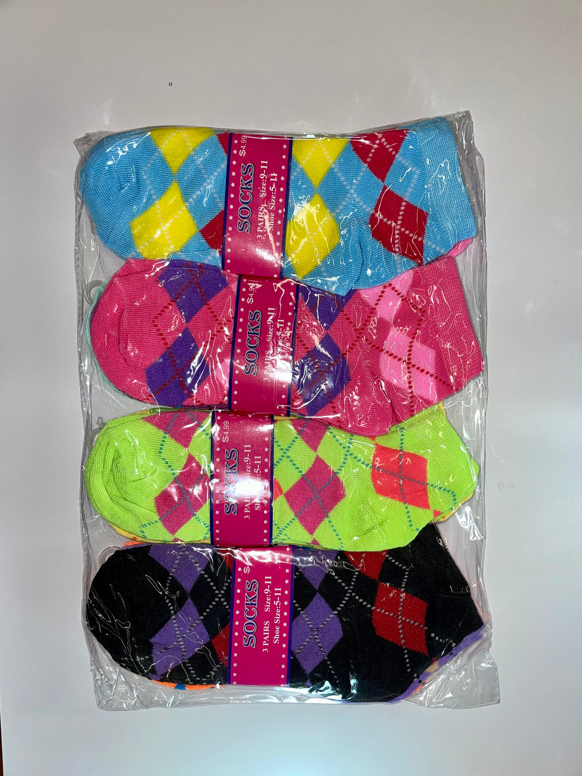 Packaged women’s ankle socks with colorful argyle patterns