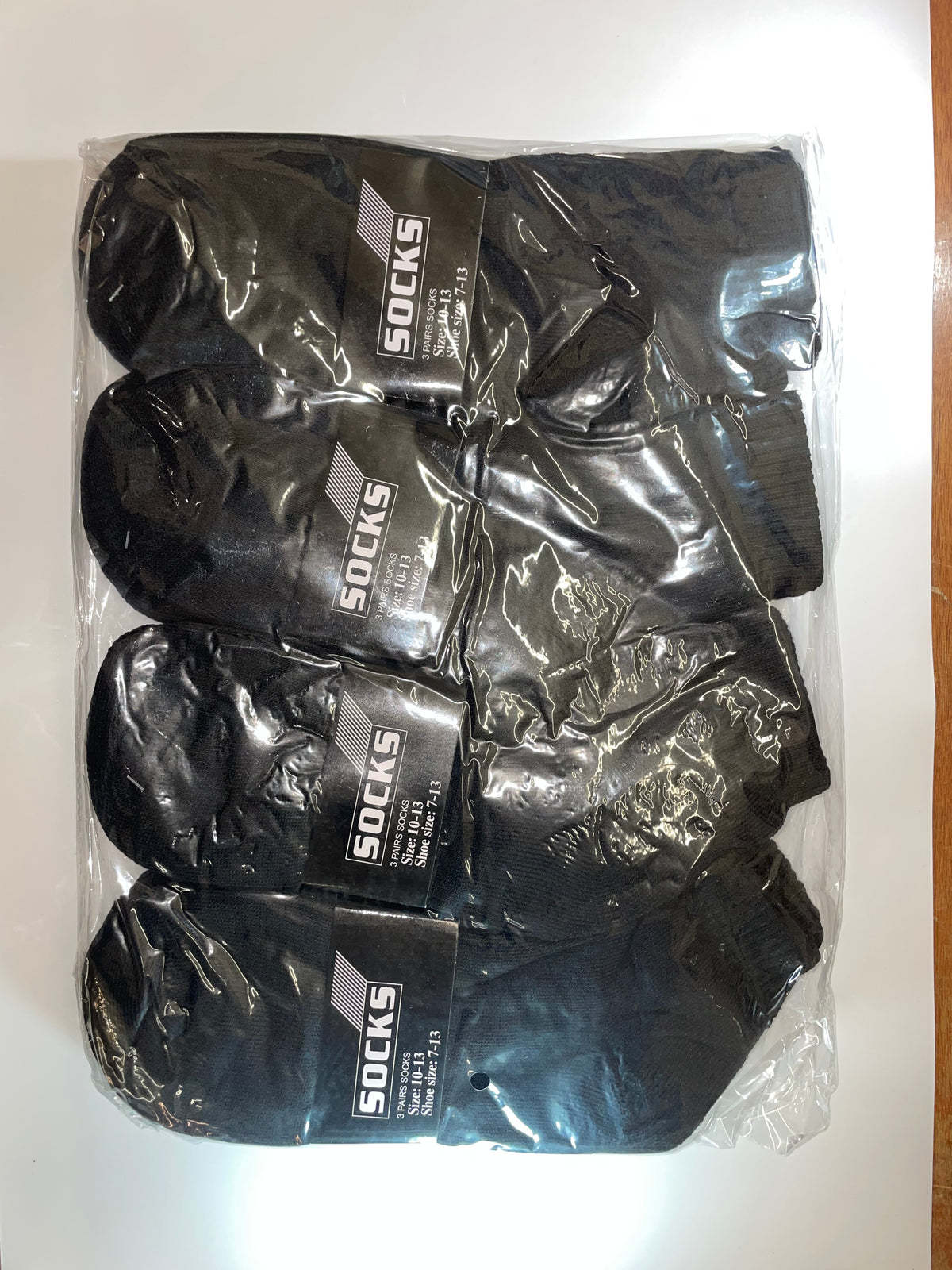 Black men’s ankle socks in clear packaging