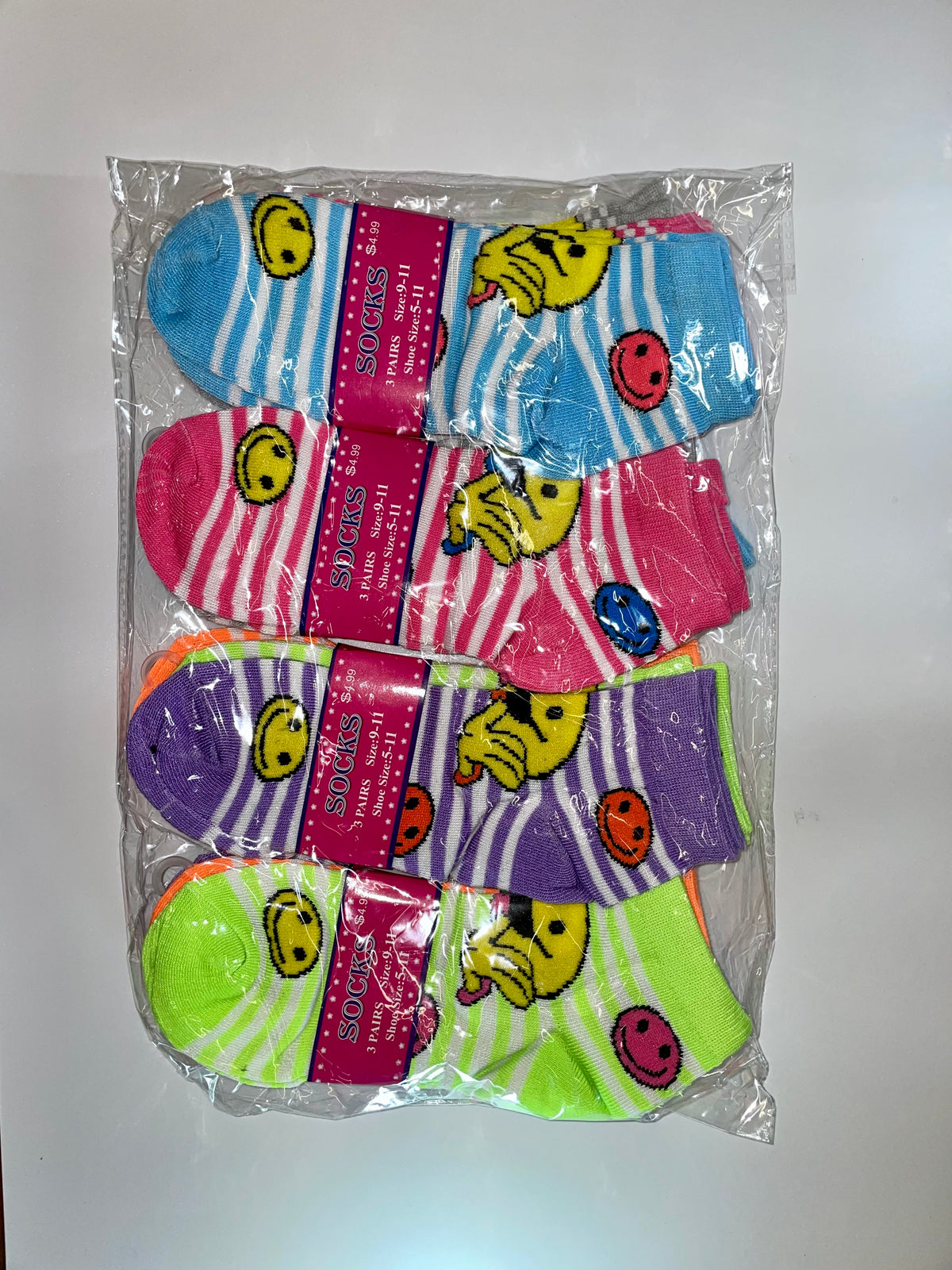 Packaged women’s ankle socks with smiley face patterns