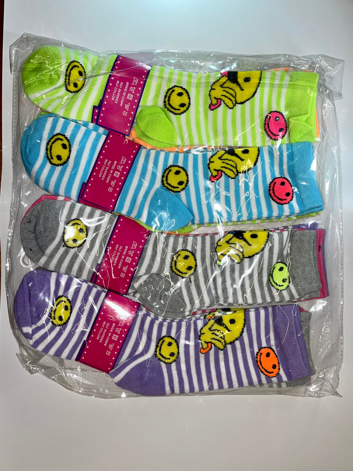 Packaged women’s crew socks with smiley faces