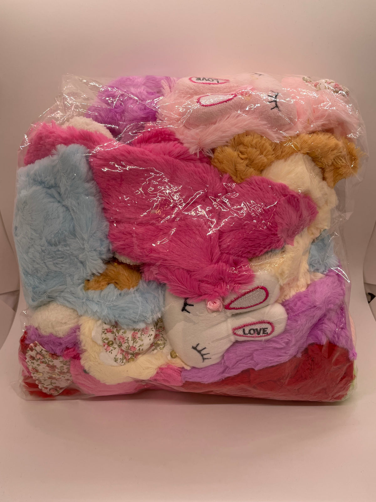 Packaged plush children’s scarves in several colors