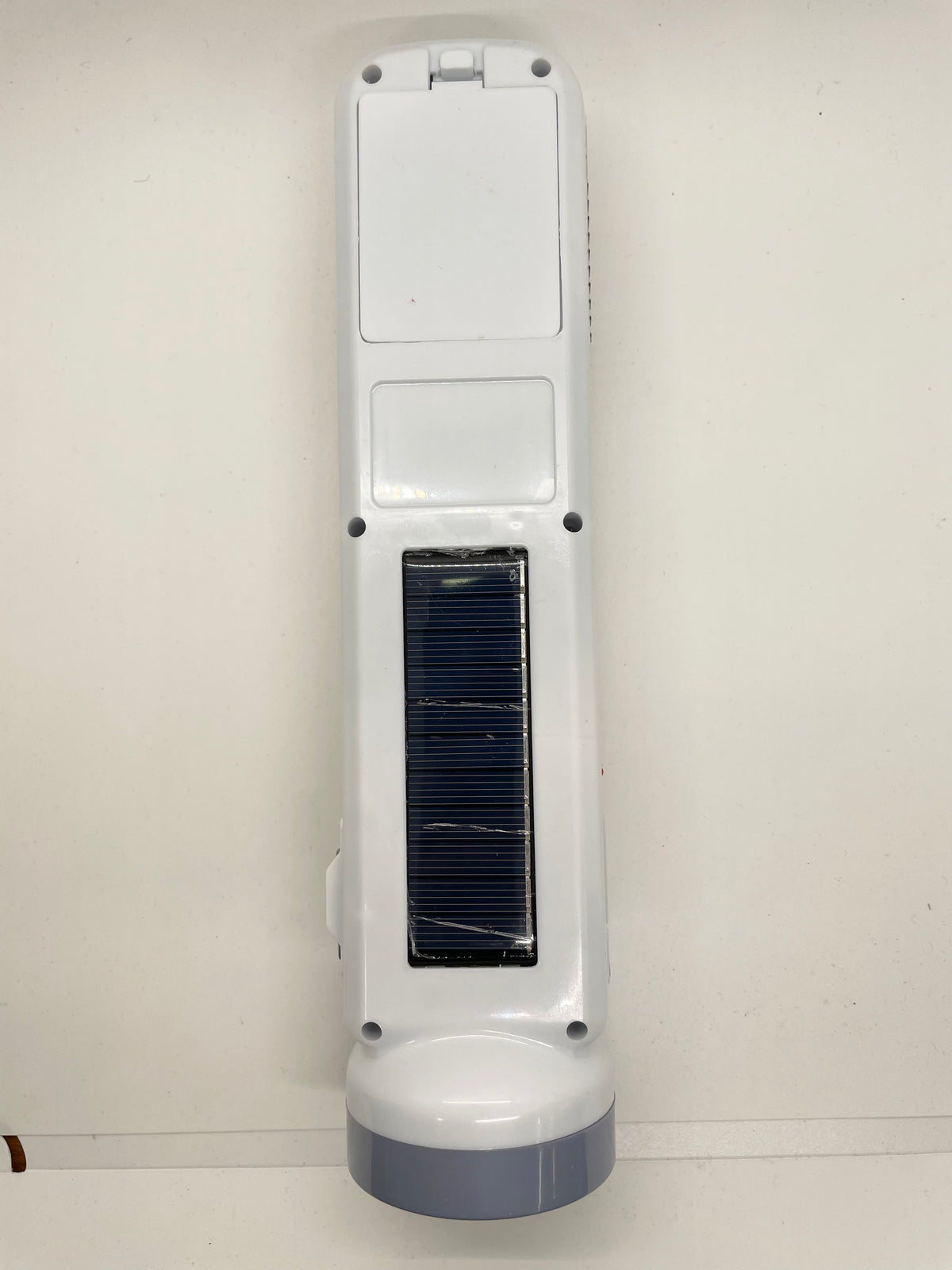 Back of rechargeable flashlight showing solar panel