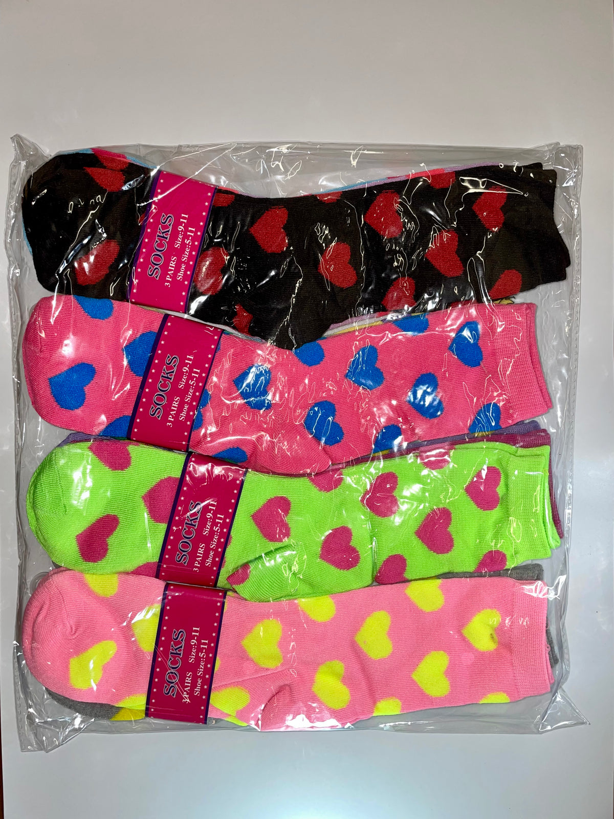 Packaged women’s crew socks with colorful hearts