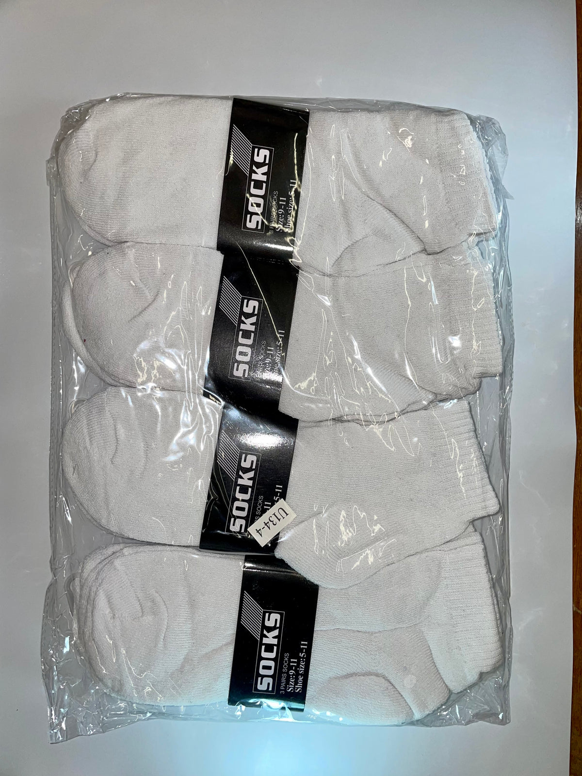 White men’s ankle socks in clear packaging